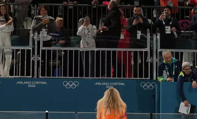 Netherlands' Jutta Leerdam looks in the crowd for her fiancé Jake Paul, left center, as she celebrates after winning the women's speedskating 1,000-meters final at the 2026 Winter Olympics, in Milan, Italy, Monday, Feb. 9, 2026. (AP Photo/Antonio Calanni)