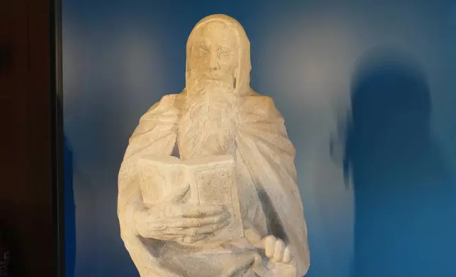 The "Bearded Saint with Book" is pictured at Milan's Cadorna station at the 2026 Winter Olympics, in Milan, Italy, Sunday, Feb. 15, 2026. (AP Photo/Antonio Calanni)