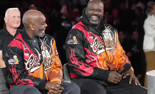 Former Miami Heat players Shaquille O'Neal, right and Gary Payton smiles during a half time celebration of the 2006 NBA champions Tuesday, Feb. 3, 2026, in Miami. (AP Photo/Marta Lavandier)