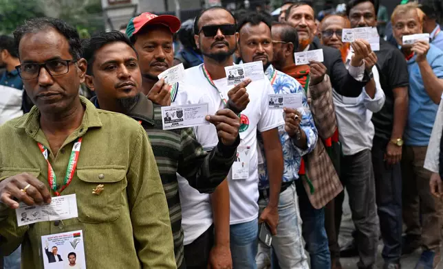 Voters wait in line outside a polling center to cast their ballots during the national parliamentary elections in Dhaka, Bangladesh, Thursday, Feb. 12, 2026. (AP Photo/Mahmud Hossain Opu)