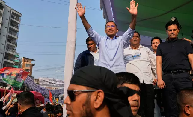 Tarique Rahman, the son of former Prime Minister Khaleda Zia and chairman of the Bangladesh Nationalist Party (BNP), waves to the crowd during an election rally in Dhaka, Bangladesh, Sunday, Feb. 8, 2026. (AP Photo/Anupam Nath)