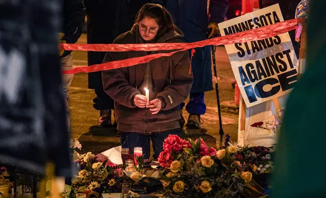 People visit a makeshift memorial for Alex Pretti, who was fatally shot by a U.S. Border Patrol officer last week, on Saturday, Jan. 31, 2026, in Minneapolis. (AP Photo/Ryan Murphy)