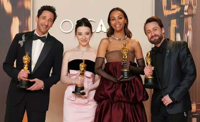 FILE - Adrien Brody, from left, winner of the award for best performance by an actor in a leading role for "The Brutalist," Mikey Madison, winner of the award for best performance by an actress in a leading role for "Anora," Zoe Saldana, winner of the award for best performance by an actress in a supporting role for "Emilia Perez," and Kieran Culkin, winner of the award for best performance by an actor in a supporting role for "A Real Pain," pose in the press room at the Oscars in Los Angeles on March 2, 2025. (Photo by Jordan Strauss/Invision/AP File)