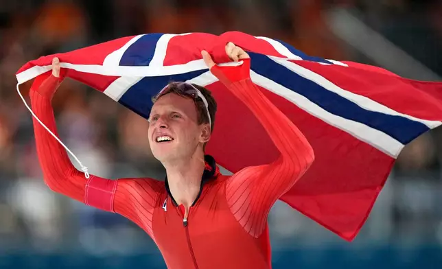 Sander Eitrem of Norway celebrates winning the gold medal in the men's 5,000 meters speedskating race at the 2026 Winter Olympics, in Milan, Italy, Sunday, Feb. 8, 2026. (AP Photo/Luca Bruno)