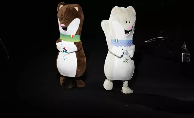 Tina and Milo, Olympics and Paralympics mascots, dance before the Olympic opening ceremony at the 2026 Winter Olympics, in Milan, Italy, Friday, Feb. 6, 2026. (AP Photo/Ben Curtis)