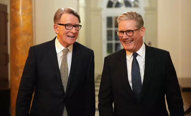 FILE - British Prime Minister Keir Starmer, right, talks with Britain's ambassador to the United States Peter Mandelson during a welcome reception at the ambassador's residence on Wednesday, Feb. 26, 2025 in Washington. (Carl Court/Pool Photo via AP, file)