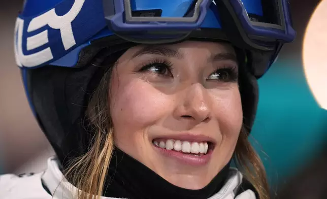 China's Eileen Gu smiles as she waits for her score while competing in the women's freestyle skiing big air qualifications at the 2026 Winter Olympics, in Livigno, Italy, Saturday, Feb. 14, 2026. (AP Photo/Abbie Parr)