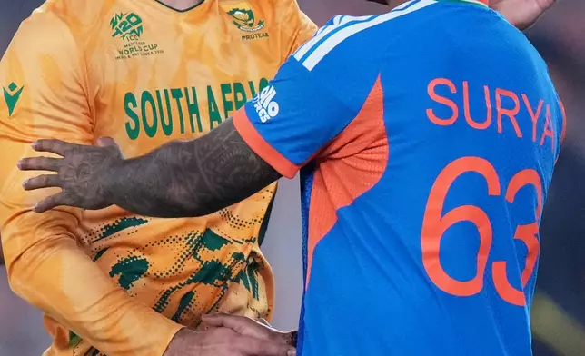 South Africa's captain Aiden Markram, left, shakes hands with India's captain Suryakumar Yadav after South Africa won their T20 World Cup cricket match against India in Ahmedabad, India, Sunday, Feb. 22, 2026. (AP Photo/Ajit Solanki)