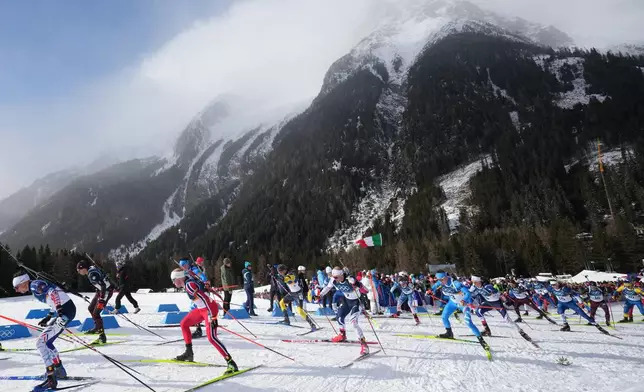 Lukas Hofer, of Italy, center right, competes in the men's 15-kilometer mass start biathlon race at the 2026 Winter Olympics in Anterselva, Italy, Friday, Feb. 20, 2026. (AP Photo/Andrew Medichini)