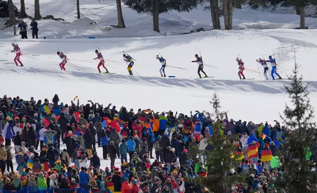 Athletes compete during the men's biathlon 15-kilometers mass start race at the 2026 Winter Olympics, in Anterselva, Italy, Friday, Feb. 20, 2026. (AP Photo/David J. Phillip)