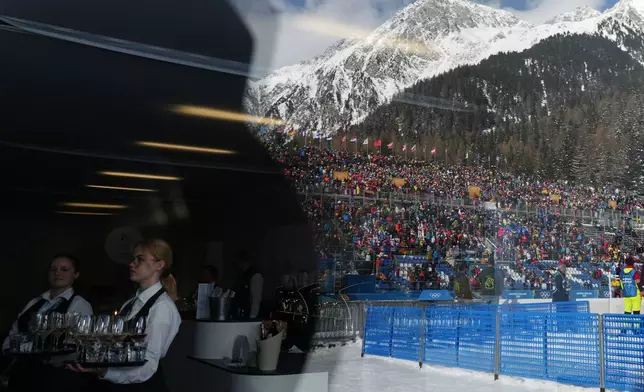 Waiters serve drinks as fans are reflected on a building ahead of the men's 15-kilometer mass start biathlon race at the 2026 Winter Olympics in Anterselva, Italy, Friday, Feb. 20, 2026. (AP Photo/Andrew Medichini)