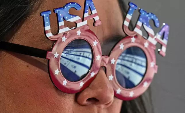 A United States supporter watches a women's curling semifinal match between Switzerland and the United States, at the 2026 Winter Olympics, in Cortina d'Ampezzo, Italy, Friday, Feb. 20, 2026. (AP Photo/Fatima Shbair)
