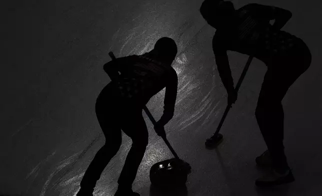 Taylor Anderson-Heide of the United States, right, and Cory Thiesse of the United States compete against Switzerland during the curling women's semifinal match at the 2026 Winter Olympics, in Cortina d'Ampezzo, Italy, Friday, Feb. 20, 2026. (AP Photo/Christophe Ena)