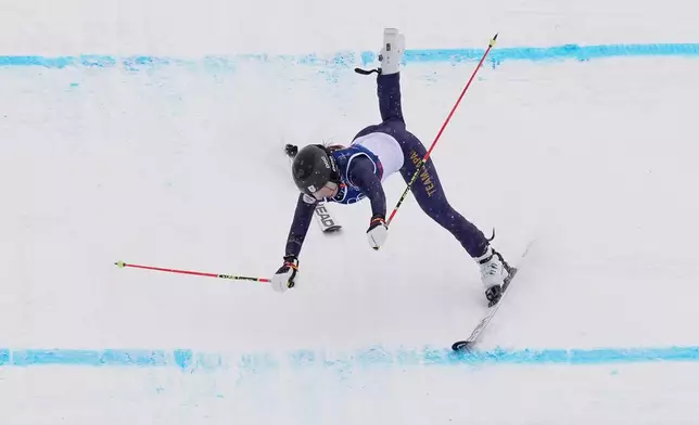Japan's Makiko Arai (27) crashes during the women's ski cross qualifications at the 2026 Winter Olympics, in Livigno, Italy, Friday, Feb. 20, 2026. (AP Photo/Rebecca Blackwell)