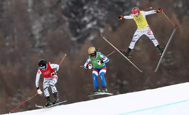 From left, Switzerland's Talina Gantenbein (5), France's Jade Grillet Aubert (6) and Switzerland's Sixtine Cousin (13) compete during the women's ski cross finals at the 2026 Winter Olympics, in Livigno, Italy, Friday, Feb. 20, 2026. (AP Photo/Gabriele Facciotti)