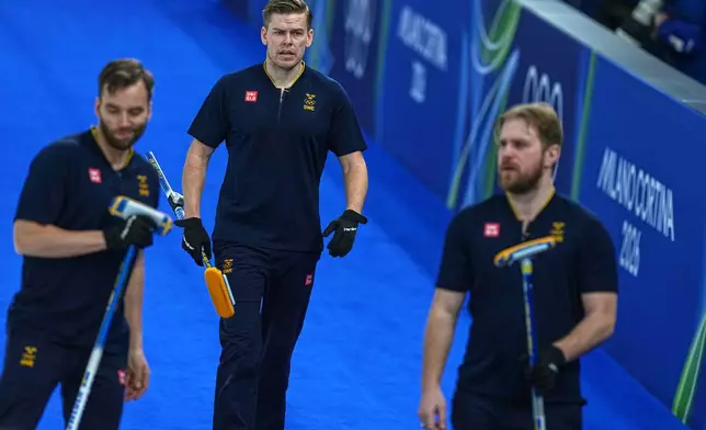 Sweden's Rasmus Wranaa, Oskar Eriksson and Christoffer Sundgren compete during the men's curling round robin session against Czechia at the 2026 Winter Olympics, in Cortina d'Ampezzo, Italy, Thursday, Feb. 19, 2026. (AP Photo/Fatima Shbair)