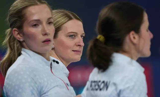 United States' Cory Thiesse, Tara Peterson, and Taylor Anderson-Heide look on, during the women's curling round robin session against Switzerland, at the 2026 Winter Olympics, in Cortina d'Ampezzo, Italy, Thursday, Feb. 19, 2026. (AP Photo/Misper Apawu)