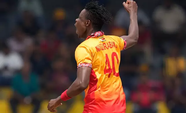 Zimbabwe's Blessing Muzarabani celebrates the wicket of Australia's Tim David during the T20 World Cup cricket match between Australia and Zimbabwe in Colombo, Sri Lanka, Friday, Feb. 13, 2026. (AP Photo/Eranga Jayawardena)