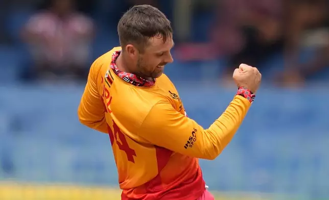 Zimbabwe's Ryan Burl celebrates the wicket of Australia's Glenn Maxwell during the T20 World Cup cricket match between Australia and Zimbabwe in Colombo, Sri Lanka, Friday, Feb. 13, 2026. (AP Photo/Eranga Jayawardena)