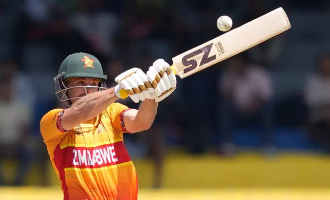 Zimbabwe's Ryan Burl plays a shot during the T20 World Cup cricket match between Australia and Zimbabwe in Colombo, Sri Lanka, Friday, Feb. 13, 2026. (AP Photo/Eranga Jayawardena)