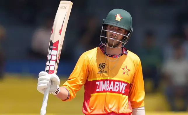 Zimbabwe's Brian Bennett celebrates his fifty runs during the T20 World Cup cricket match between Australia and Zimbabwe in Colombo, Sri Lanka, Friday, Feb. 13, 2026. (AP Photo/Eranga Jayawardena)