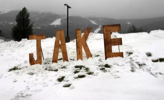 FILE - A wooden sign honoring snowboard pioneer Jake Burton Carpenter sits at the entranceway to a parking lot at Stowe Mountain Resort, Nov. 22, 2019, in Stowe, Vt. (AP Photo/Lisa Rathke, File)