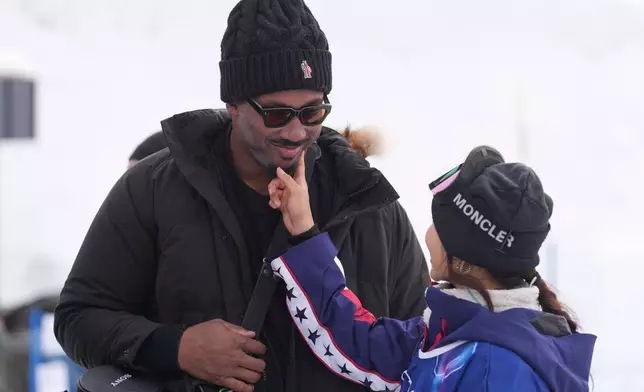 Cleveland Browns' Myles Garrett, left, and United States' Chloe Kim stand after the women's snowboarding halfpipe qualifications at the 2026 Winter Olympics, in Livigno, Italy, Wednesday, Feb. 11, 2026. (AP Photo/Lindsey Wasson)