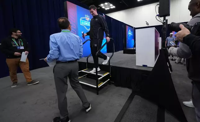 Indiana quarterback Fernando Mendoza leaves after speaking during a news conference at the NFL football scouting combine in Indianapolis, Friday, Feb. 27, 2026. (AP Photo/Julio Cortez)