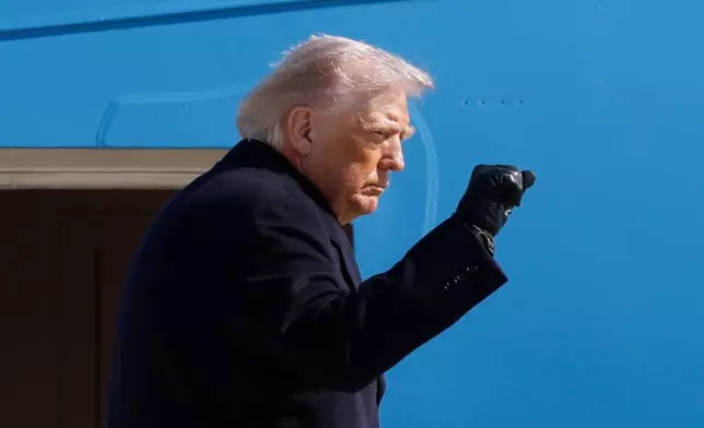 President Donald Trump gestures from the stairs of Air Force One upon his arrival at Joint Base Andrews, Md., Friday, Feb. 27, 2025. (AP Photo/Luis M. Alvarez)