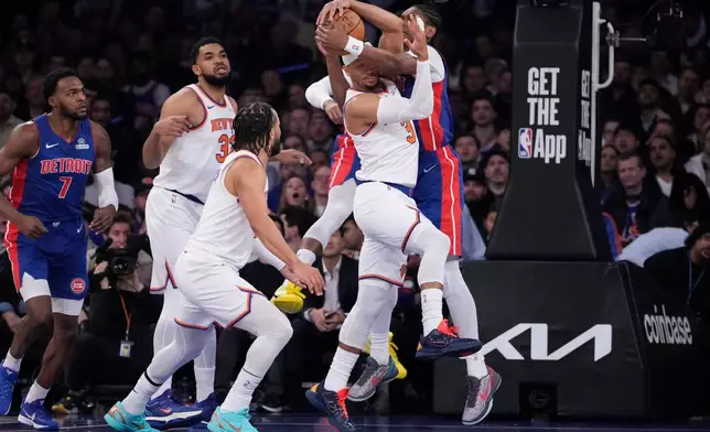 Detroit Pistons guard Ausar Thompson (9) fights for control of the ball with New York Knicks guard Josh Hart (3) during the first half of an NBA basketball game, Thursday, Feb. 19, 2026, in New York. (AP Photo/Yuki Iwamura)