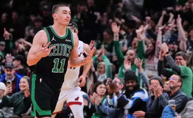 Boston Celtics guard Payton Pritchard (11) celebrates after hitting a 3-point basket during the second half of an NBA basketball game against the Miami Heat, Friday, Feb. 6, 2026, in Boston. (AP Photo/Charles Krupa)