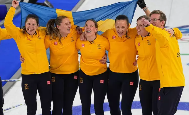 Sweden's Anna Hasselborg, Sara McManus, Sofia Scharback and Agnes Knochenhauer celebrate defeating Switzerland to win a women's curling gold medal match, at the 2026 Winter Olympics, in Cortina d'Ampezzo, Italy, Sunday, Feb. 22, 2026. (AP Photo/Fatima Shbair)