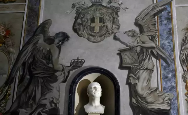 A painting inside the Basilica of San Lorenzo in Lucina in Rome depicting a cherub, right, that bore a striking resemblance to Italian Premier Giorgia Meloni shows signs of alteration after the face was removed, Wednesday, Feb. 4, 2026. (Cecilia Fabiano/LaPresse via AP)