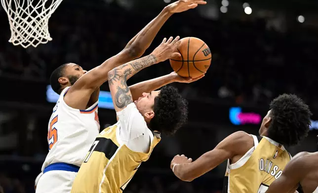 Washington Wizards guard Will Riley goes to shoot against New York Knicks guard Mikal Bridges during the first half of an NBA basketball game, Tuesday, Feb. 3, 2026, in Washington. (AP Photo/John McDonnell)