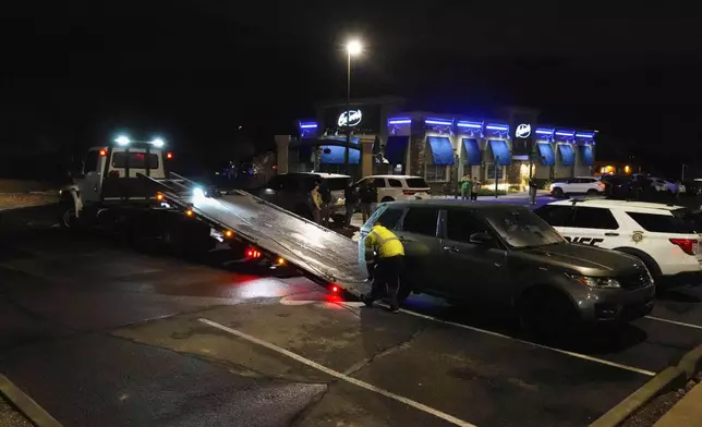 Pima County sheriff and FBI take away a Range Rover from a Culver’s parking lot in Tucson, Ariz. early Saturday, Feb. 14, 2026. (AP Photo/Ty ONeil)