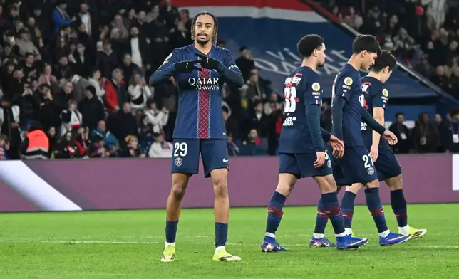 PSG's Bradley Barcola, left, celebrates after scoring his side's second goal during the French League One soccer match between Paris Saint-Germain and Metz in Paris, France, Saturday, Feb. 21, 2026. (AP Photo/Emma Da Silva)