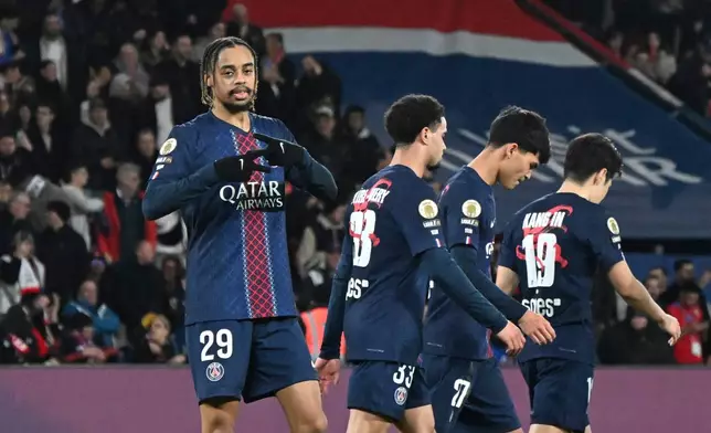 PSG's Bradley Barcola, left, celebrates after scoring his side's second goal during the French League One soccer match between Paris Saint-Germain and Metz in Paris, France, Saturday, Feb. 21, 2026. (AP Photo/Emma Da Silva)