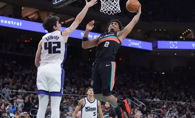 San Antonio Spurs guard Dylan Harper (2) shoots the ball against Sacramento Kings center Maxime Raynaud (42) during the second half of an NBA basketball game in Austin, Texas, Saturday, Feb. 21, 2026. (AP Photo/Eric Gay)
