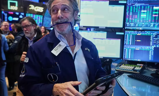 Trader John Romolo works on the floor of the New York Stock Exchange, Wednesday, Feb. 11, 2026. (AP Photo/Richard Drew)