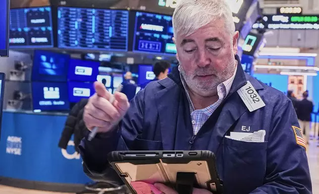 Trader Edward McCarthy works on the floor of the New York Stock Exchange, Wednesday, Feb. 11, 2026. (AP Photo/Richard Drew)