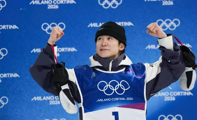 Japan's Yuto Totsuka celebrates winning the gold medal in the men's snowboarding halfpipe finals at the 2026 Winter Olympics, in Livigno, Italy, Friday, Feb. 13, 2026. (AP Photo/Abbie Parr)