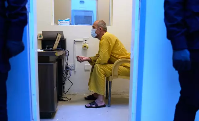 A suspected Islamic State militant arrives for questioning, after he was transferred from Syria to Iraq, at Al-Karkh Central Prison in Baghdad, Iraq, Thursday, Feb. 12, 2026. (AP Photo/Hadi Mizban)