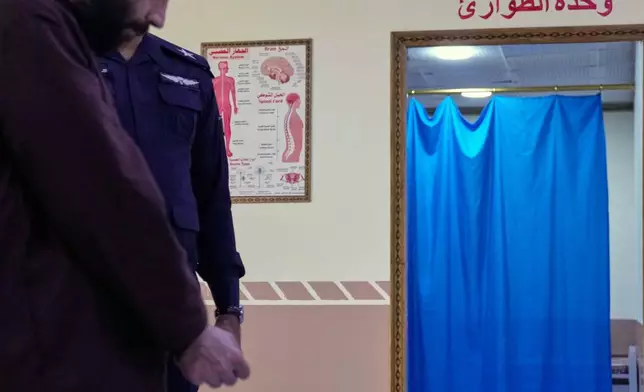 A suspected Islamic State militant who was transferred from Syria to Iraq, arrives for medical examination, in Al-Karkh Central Prison in Baghdad, Iraq, Thursday, Feb. 12, 2026. (AP Photo/Hadi Mizban)