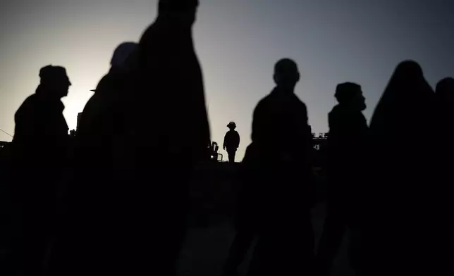 Palestinian worshippers pass through the Israeli military Qalandia checkpoint between the West Bank city of Ramallah and Jerusalem on their way to attend Friday prayers at Al-Aqsa Mosque during the Muslim holy month of Ramadan, Friday, Feb. 20, 2026. (AP Photo/Leo Correa)