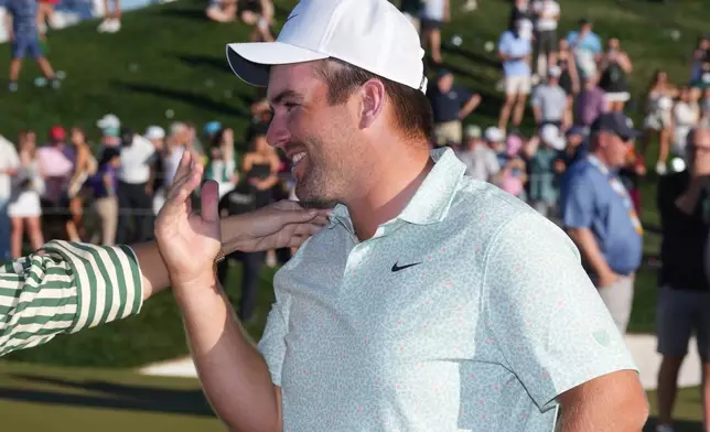 Chris Gotterup smiles at the 18th green after his playoff win in final round of the Phoenix Open golf tournament Sunday, Feb. 8, 2026, in Scottsdale, Ariz. (AP Photo/Ross D. Franklin)
