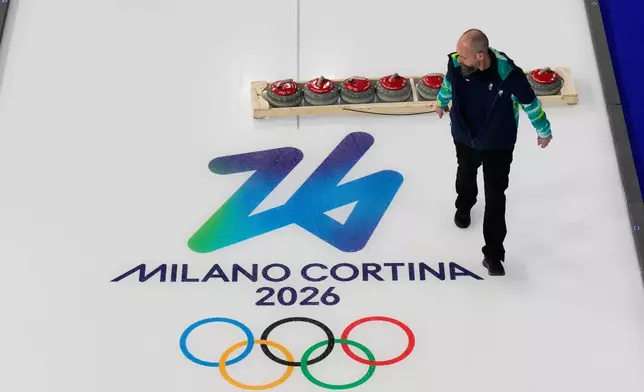 Preparations for the first curling competition are made at the 2026 Winter Olympics in Cortina d'Ampezzo, Italy, Wednesday, Feb. 4, 2026. (AP Photo/David J. Phillip)