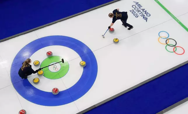 Sweden's Rasmus &amp; Isabella Wranaa compete during a curling mixed doubles session against South Korea at the 2026 Winter Olympics in Cortina d'Ampezzo, Italy, Wednesday, Feb. 4, 2026. (AP Photo/David J. Phillip)