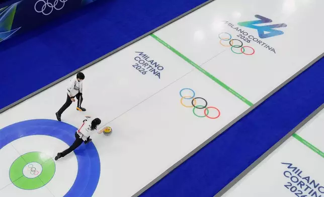 South Korea's Jeong Yeong-seok and Kim Seon-yeong compete during a curling mixed doubles session at the 2026 Winter Olympics in Cortina d'Ampezzo, Italy, Wednesday, Feb. 4, 2026. (AP Photo/David J. Phillip)