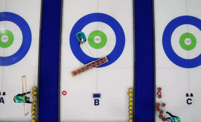 Preparations for the first curling competition are made at the 2026 Winter Olympics in Cortina d'Ampezzo, Italy, Wednesday, Feb. 4, 2026. (AP Photo/David J. Phillip)