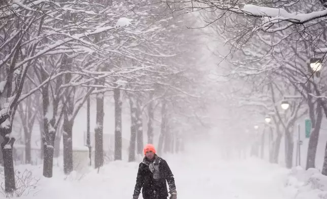 A man walks along the Hudson River Greenway in lower Manhattan during a snow storm, Monday, Feb. 23, 2026, in New York. (AP Photo/Seth Wenig)